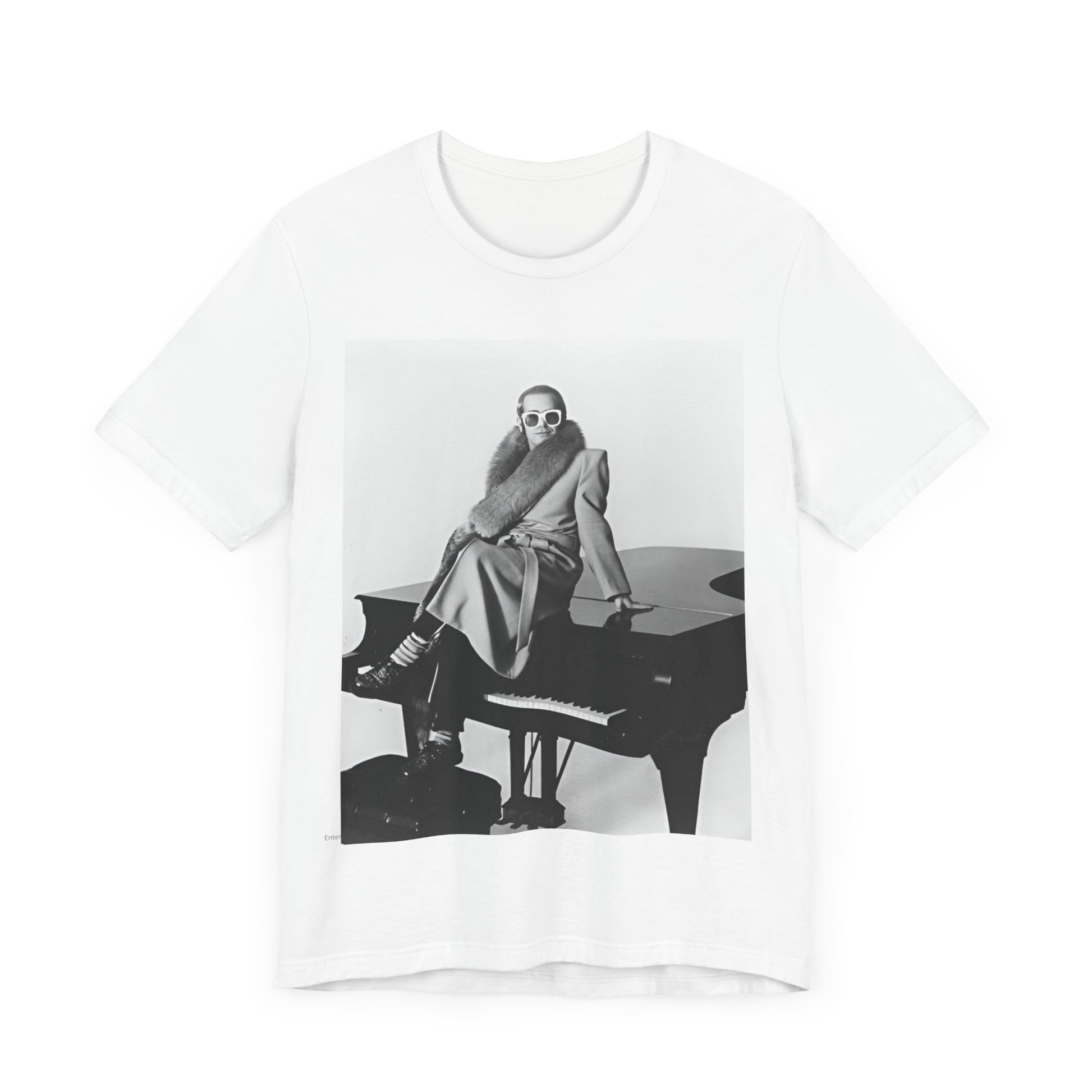 A black graphic t-shirt featuring a black and white photo of Elton John playing the piano.