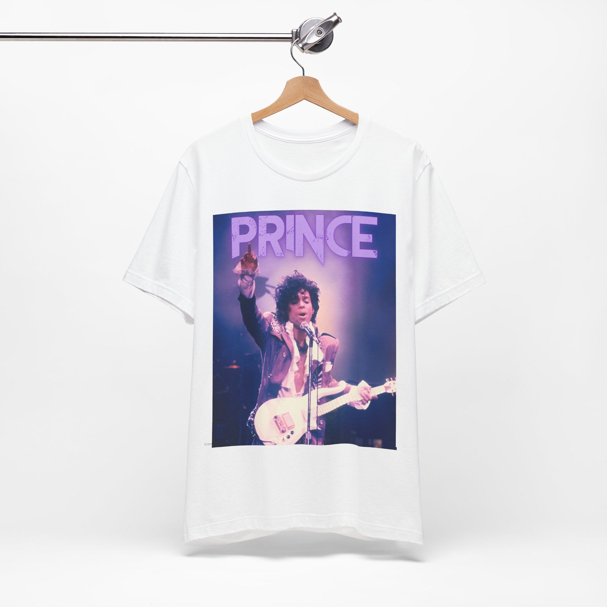 A black graphic t-shirt featuring a retro graphic related to Prince's 'Purple Rain' album era.