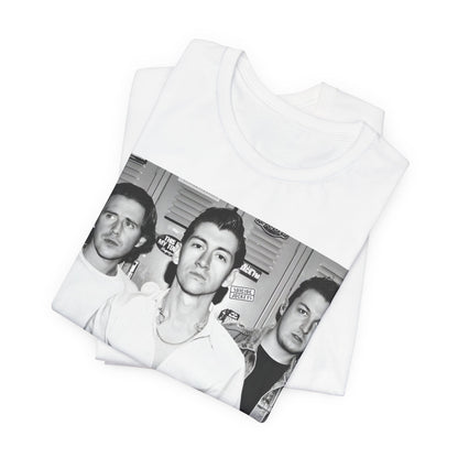 A black graphic t-shirt featuring a vintage-style design related to Arctic Monkeys' 'AM' album era, possibly with the album art or band imagery.