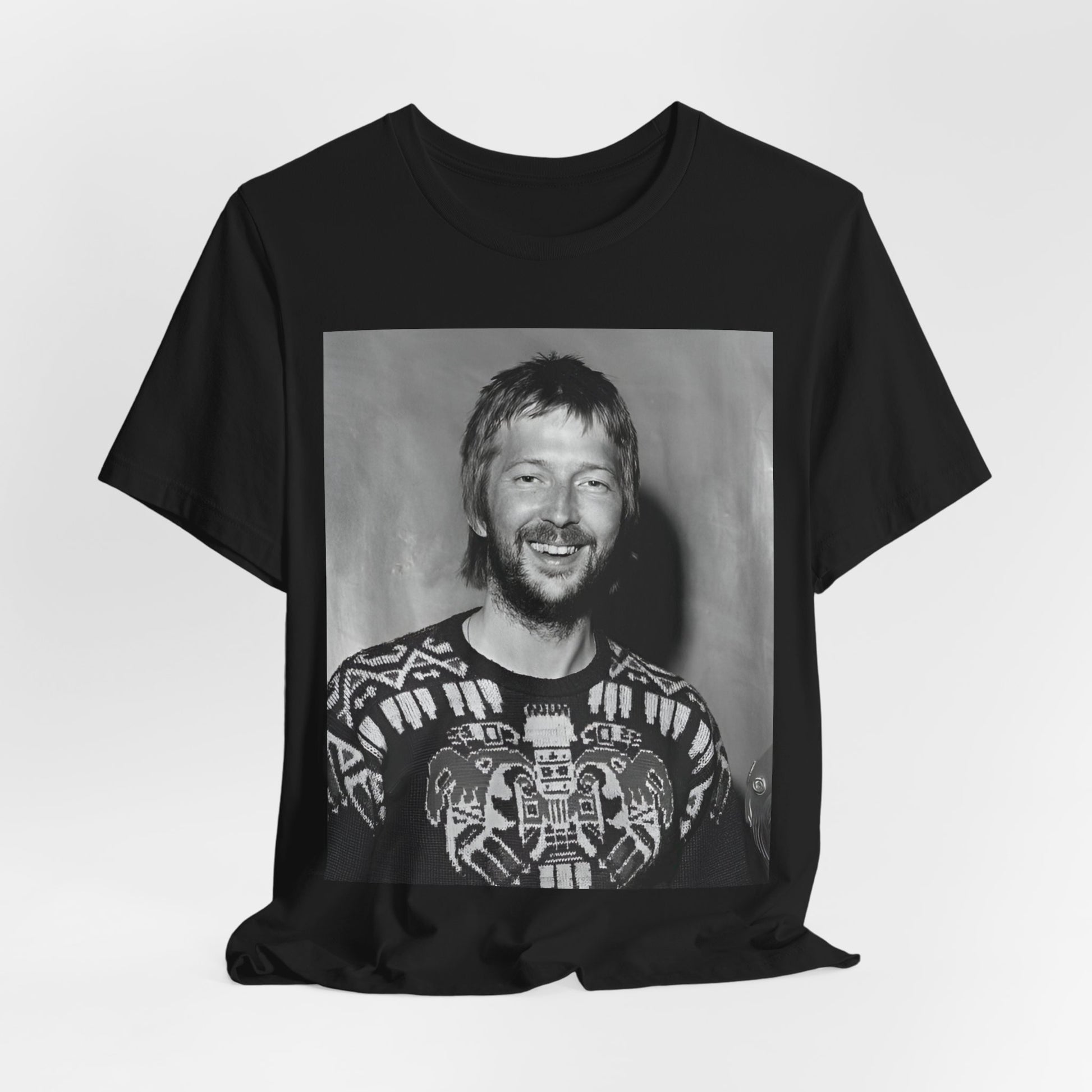 A black graphic t-shirt featuring a 70s photo portrait of Eric Clapton.