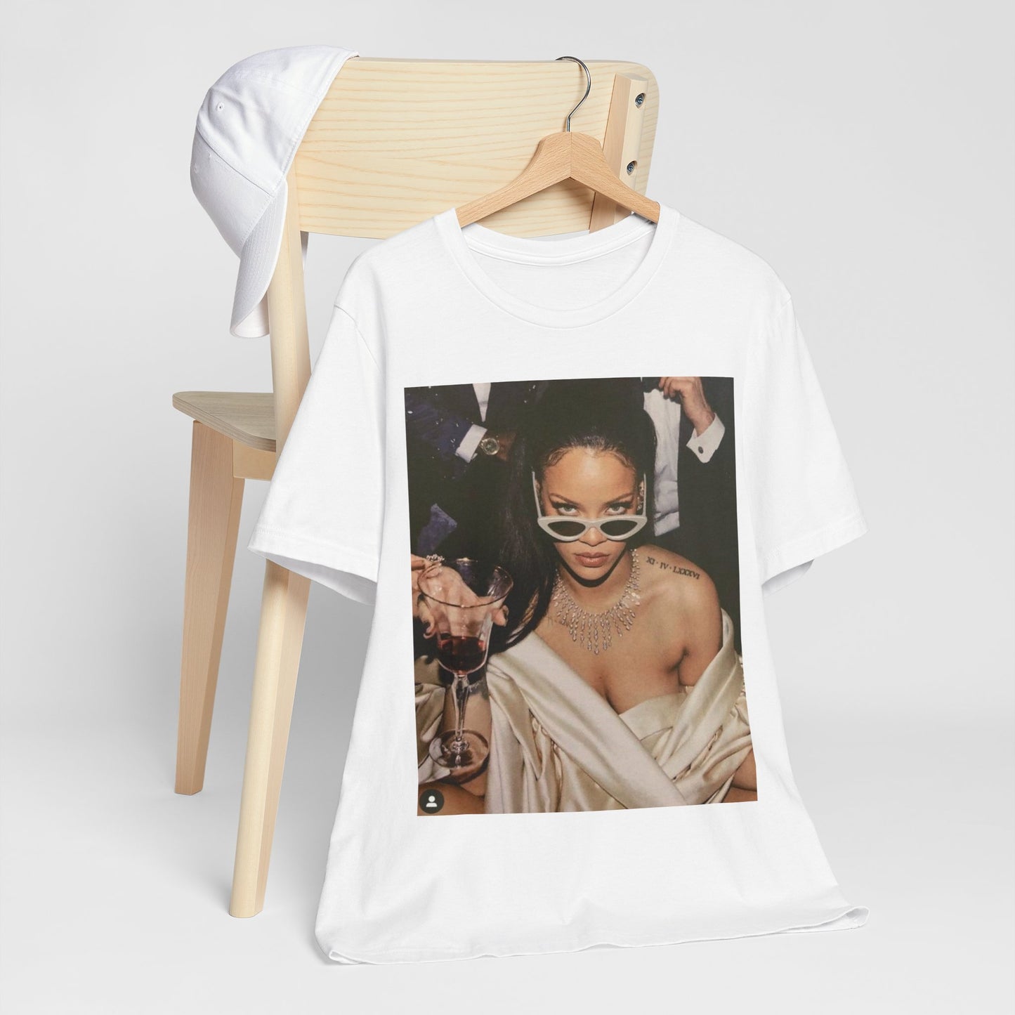 A black graphic t-shirt featuring a graphic of Rihanna as a 'Bad Gal Riri' fashion icon.