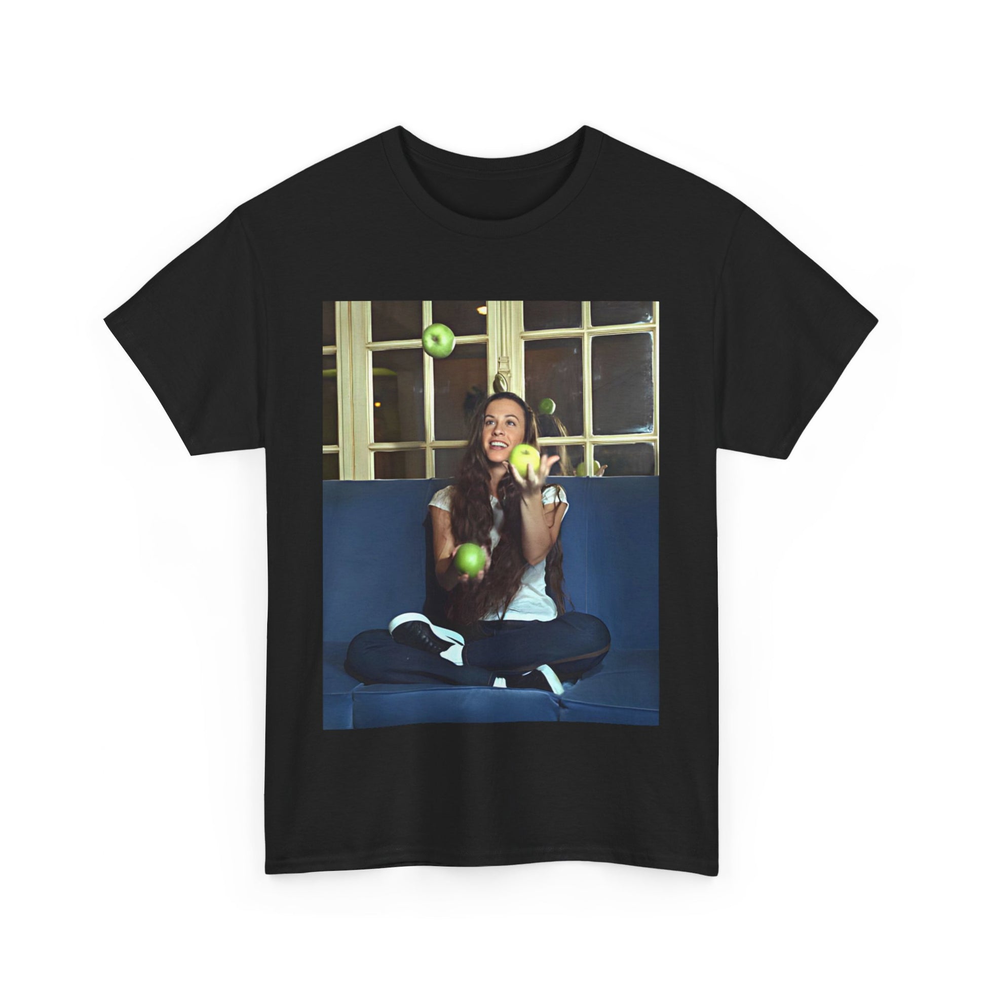 A black graphic t-shirt featuring a candid photo of Alanis Morissette sitting on a couch, looking relaxed or thoughtful.
