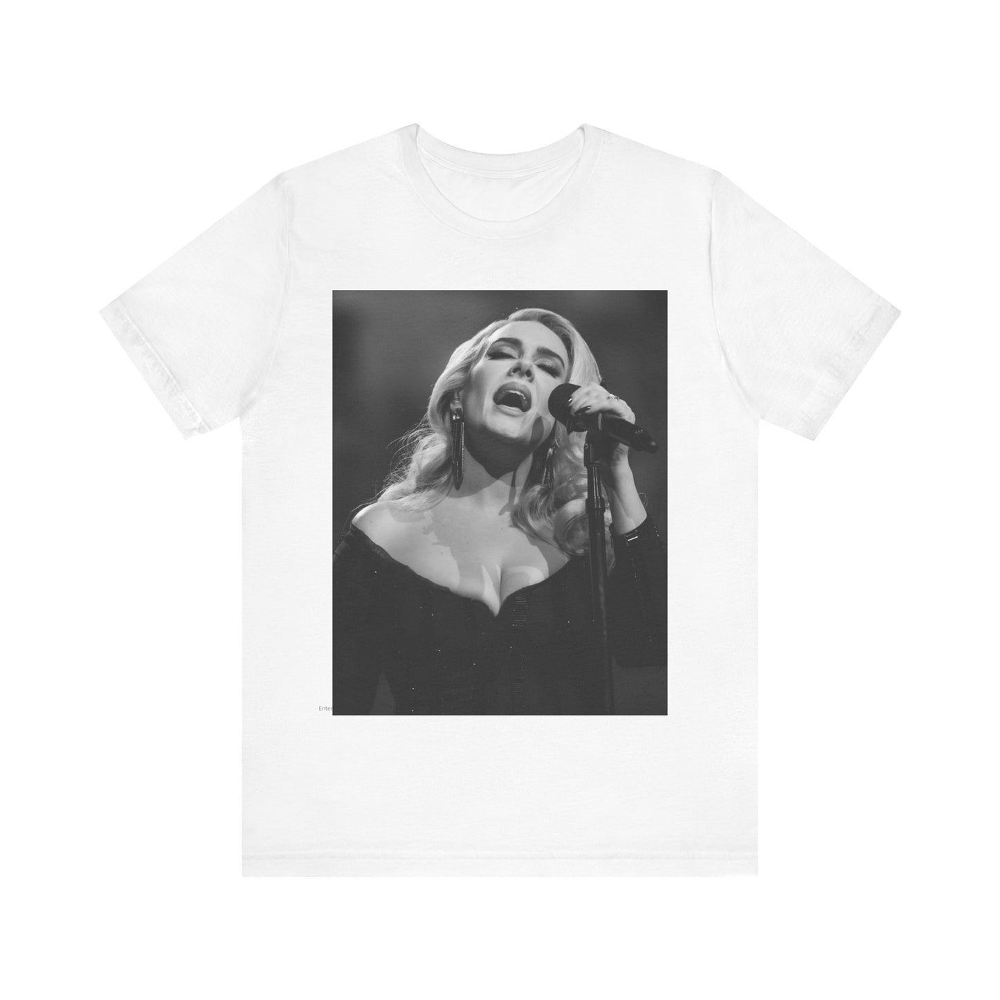 A black graphic t-shirt featuring a dynamic image of Adele performing on stage, with lighting effects, likely from her 'One Night Only' concert special.