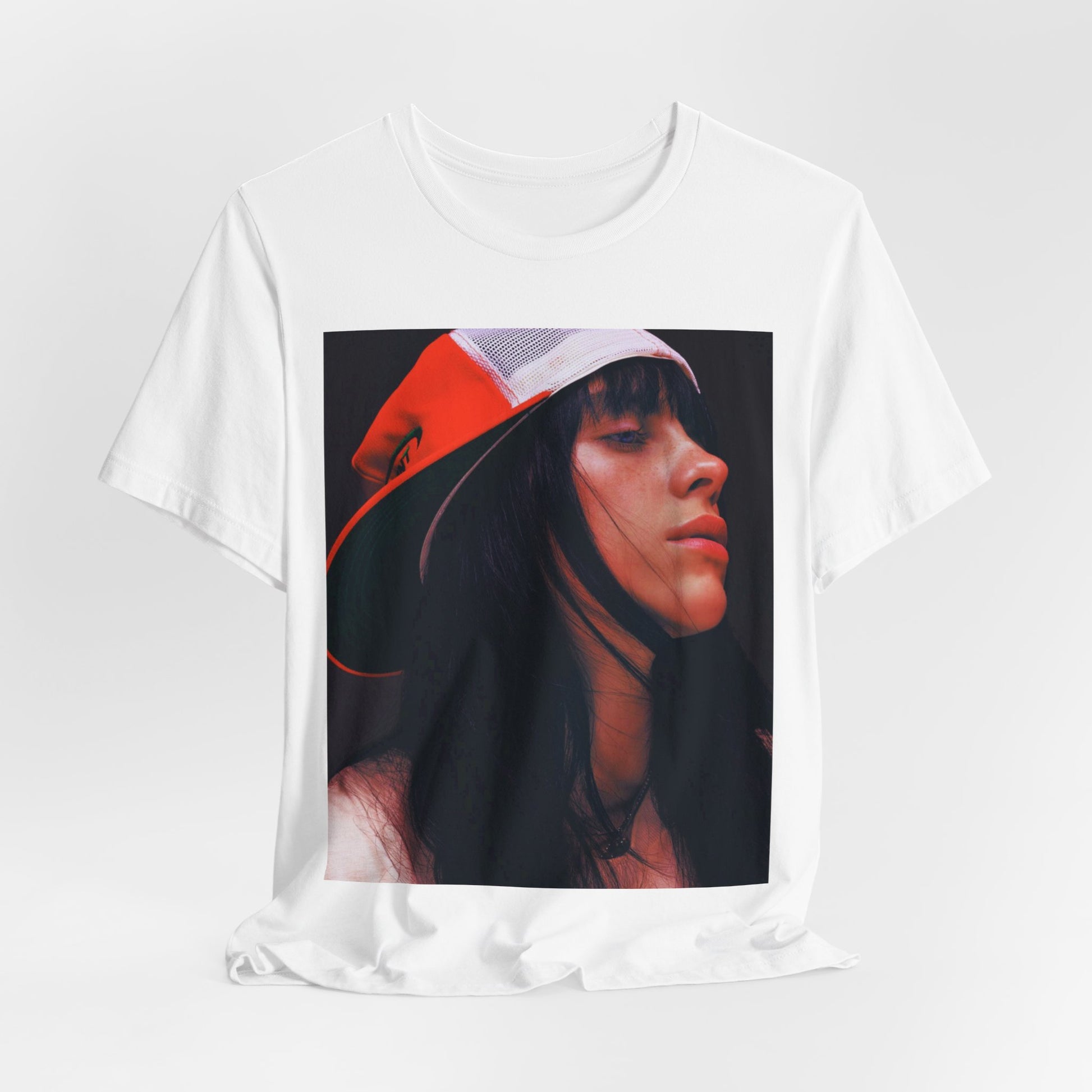 A graphic t-shirt featuring the name 'Billie Eilish' in a raw, urban street-style font.