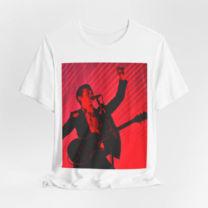 A black graphic t-shirt featuring a dynamic graphic or photo of Arctic Monkeys performing live in concert.