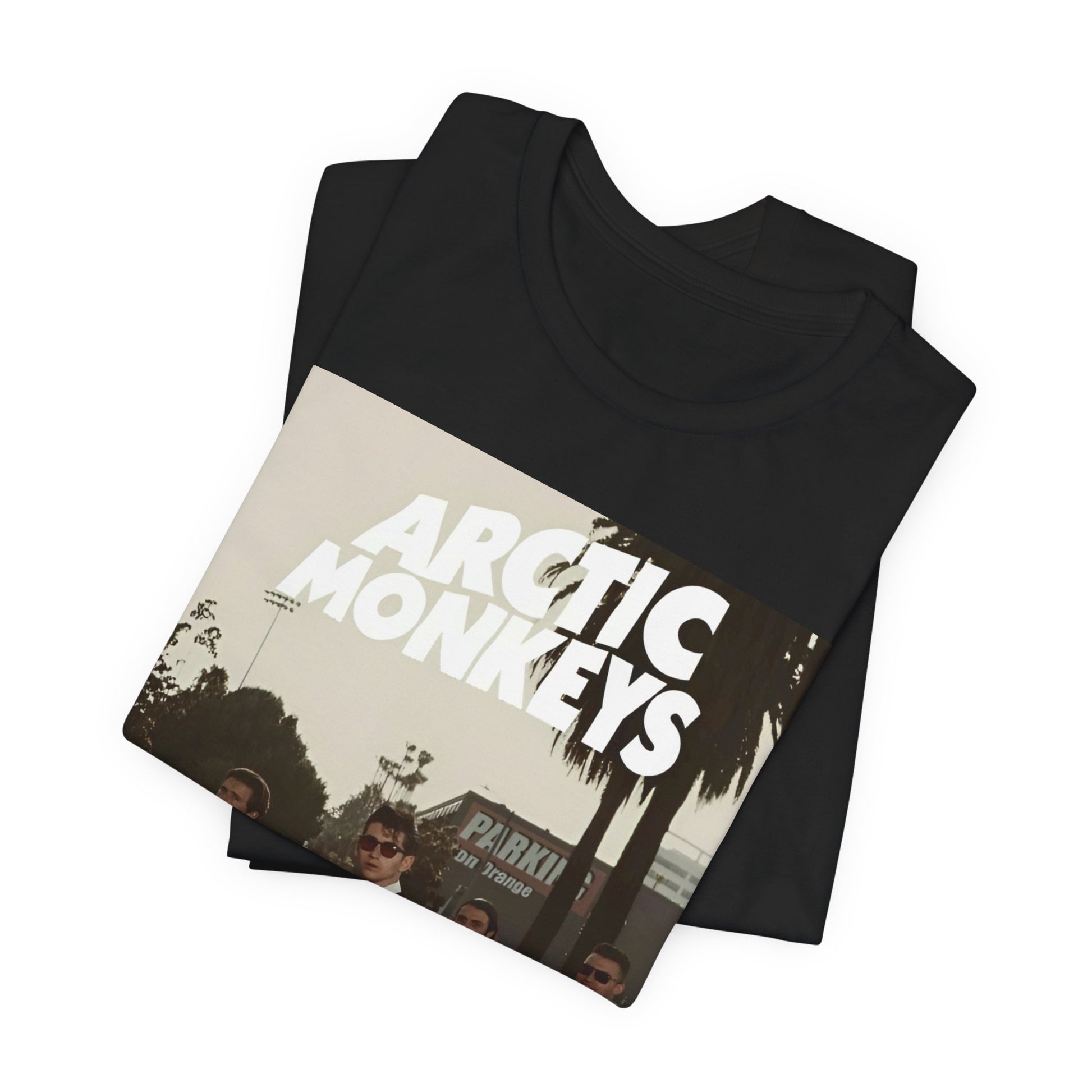 A black graphic t-shirt featuring Arctic Monkeys in a pose or setting similar to the iconic 'Abbey Road' album cover.
