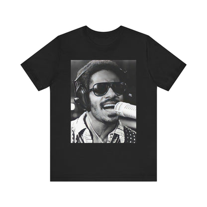 A black graphic t-shirt featuring a graphic of Stevie Wonder as a timeless visionary.