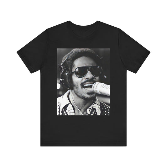 A black graphic t-shirt featuring a graphic of Stevie Wonder as a timeless visionary.