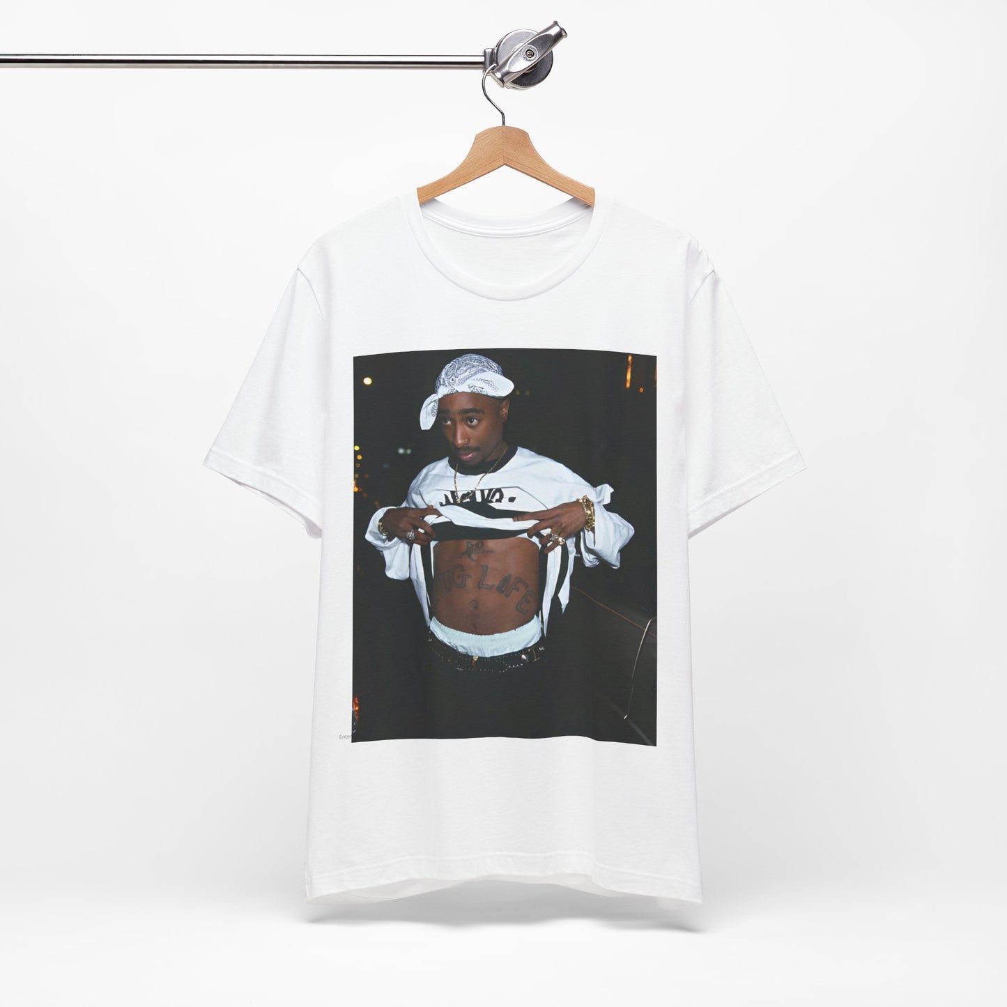 A black graphic t-shirt featuring a graphic of Tupac Shakur (2Pac).
