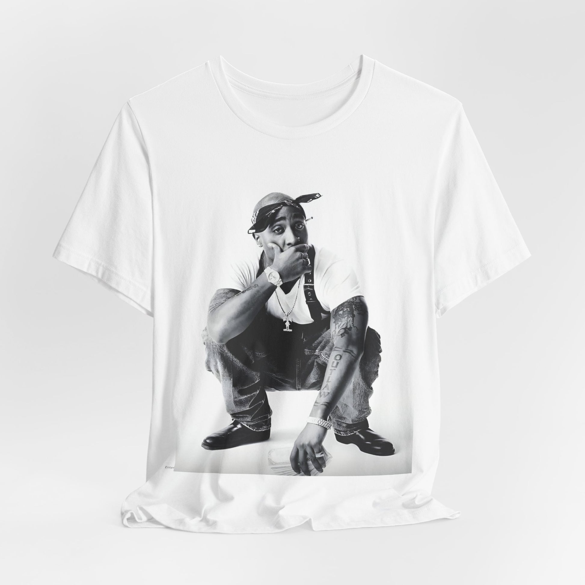 A black graphic t-shirt featuring a graphic of Tupac with a conscious rap vibe.