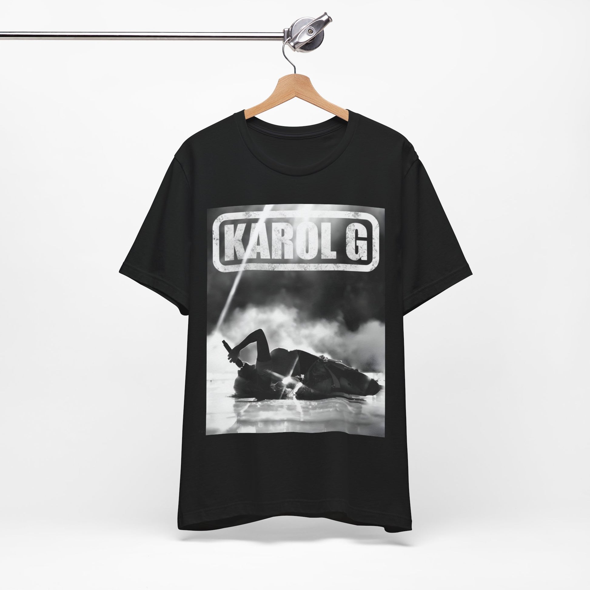 A black graphic t-shirt featuring a black and white graphic or photo of Karol G performing live on stage.