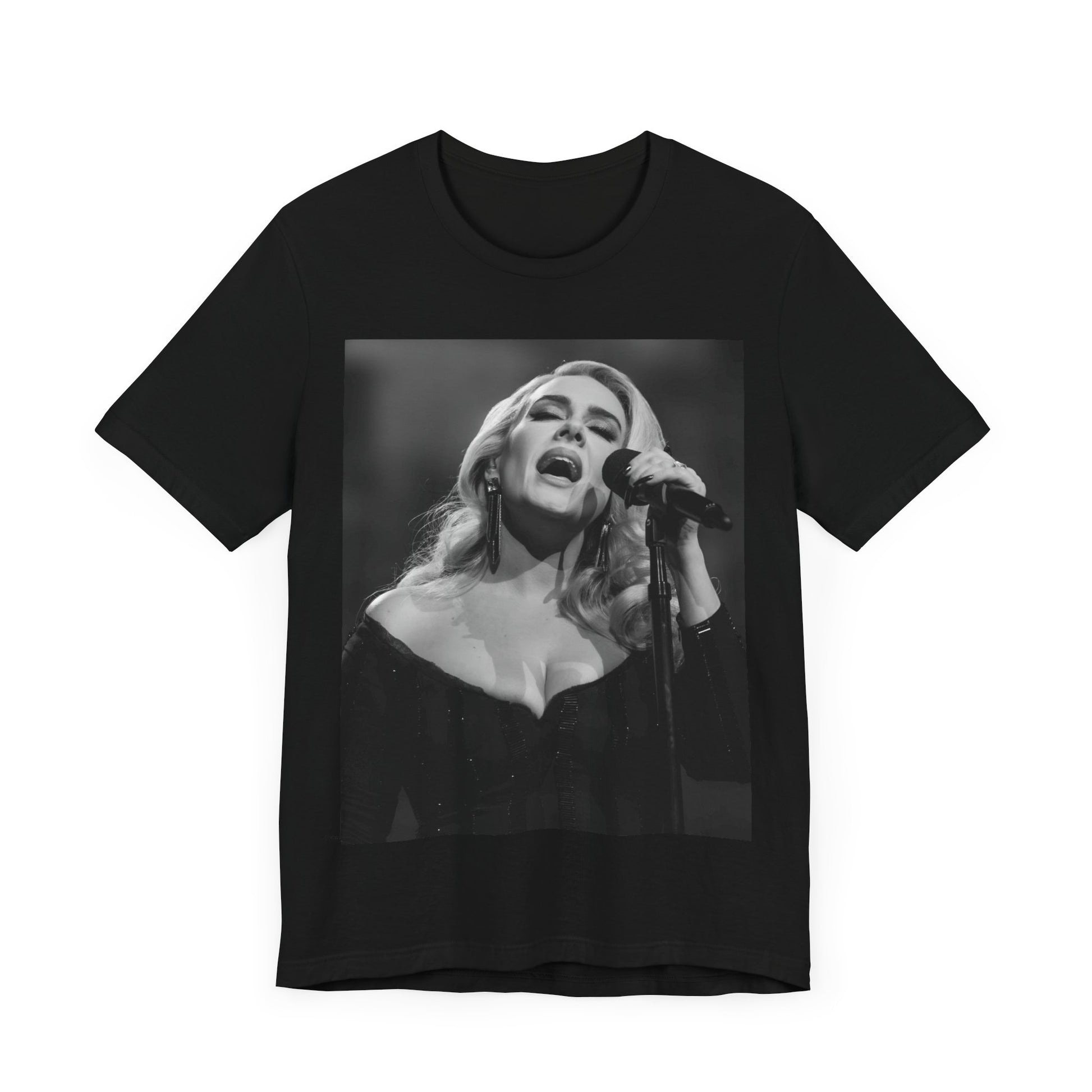 A black graphic t-shirt featuring a dynamic image of Adele performing on stage, with lighting effects, likely from her 'One Night Only' concert special.