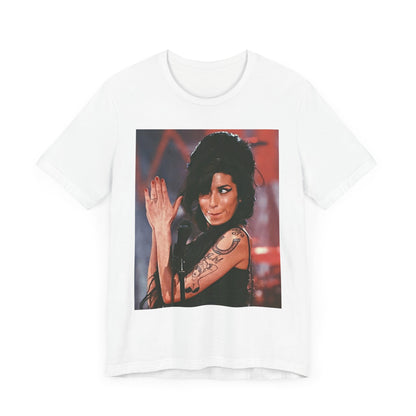 A black graphic t-shirt featuring a photo of Amy Winehouse performing live on stage in 2008, with her signature beehive and expressive singing.