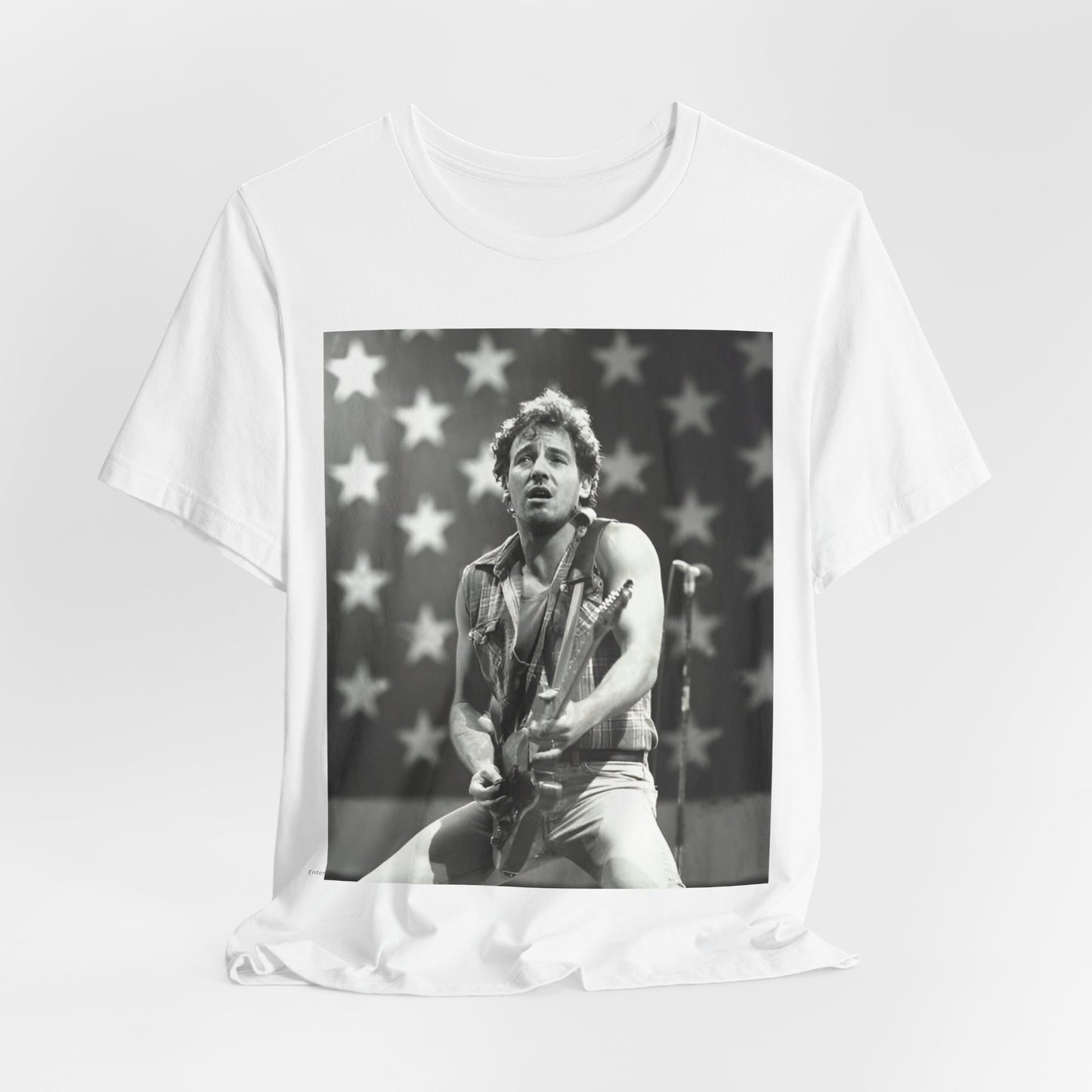 A black graphic t-shirt featuring a black and white graphic of Bruce Springsteen with an American flag background or elements.
