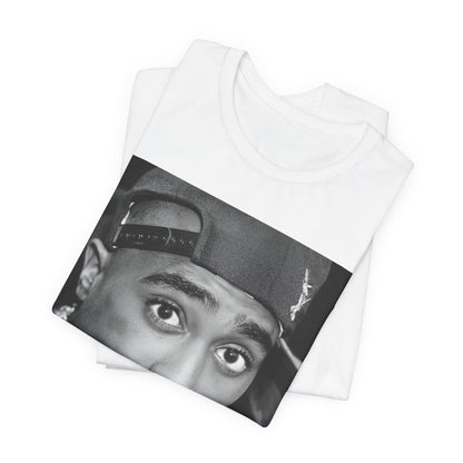 A black graphic t-shirt featuring a bold graphic of Tupac as a rap superstar.