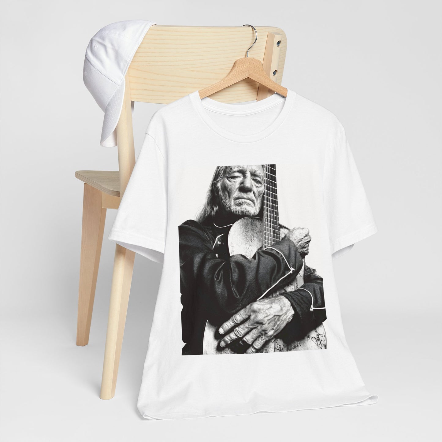 A black graphic t-shirt featuring a vintage country legend graphic of Willie Nelson.