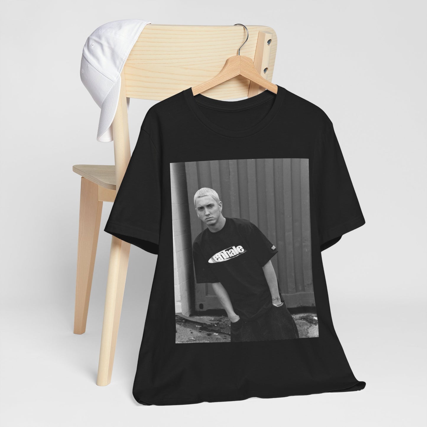 A black graphic t-shirt featuring a graphic of Eminem with a Detroit hip hop aesthetic.