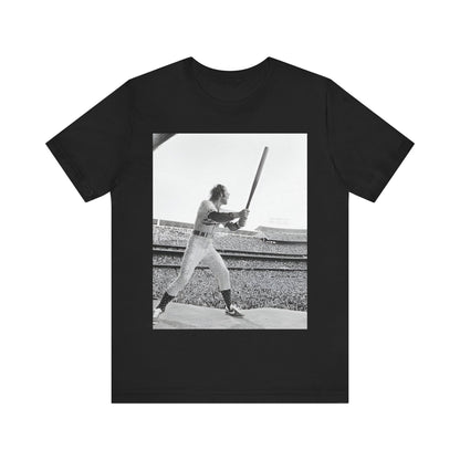 A black graphic t-shirt featuring a black and white graphic or photo related to Elton John's 1975 tour in America.