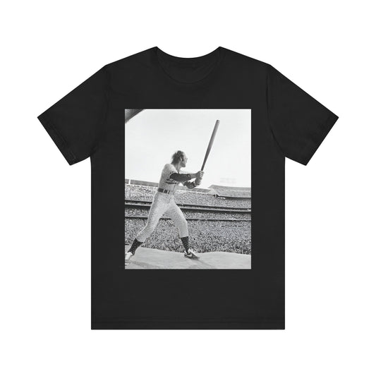 A black graphic t-shirt featuring a black and white graphic or photo related to Elton John's 1975 tour in America.