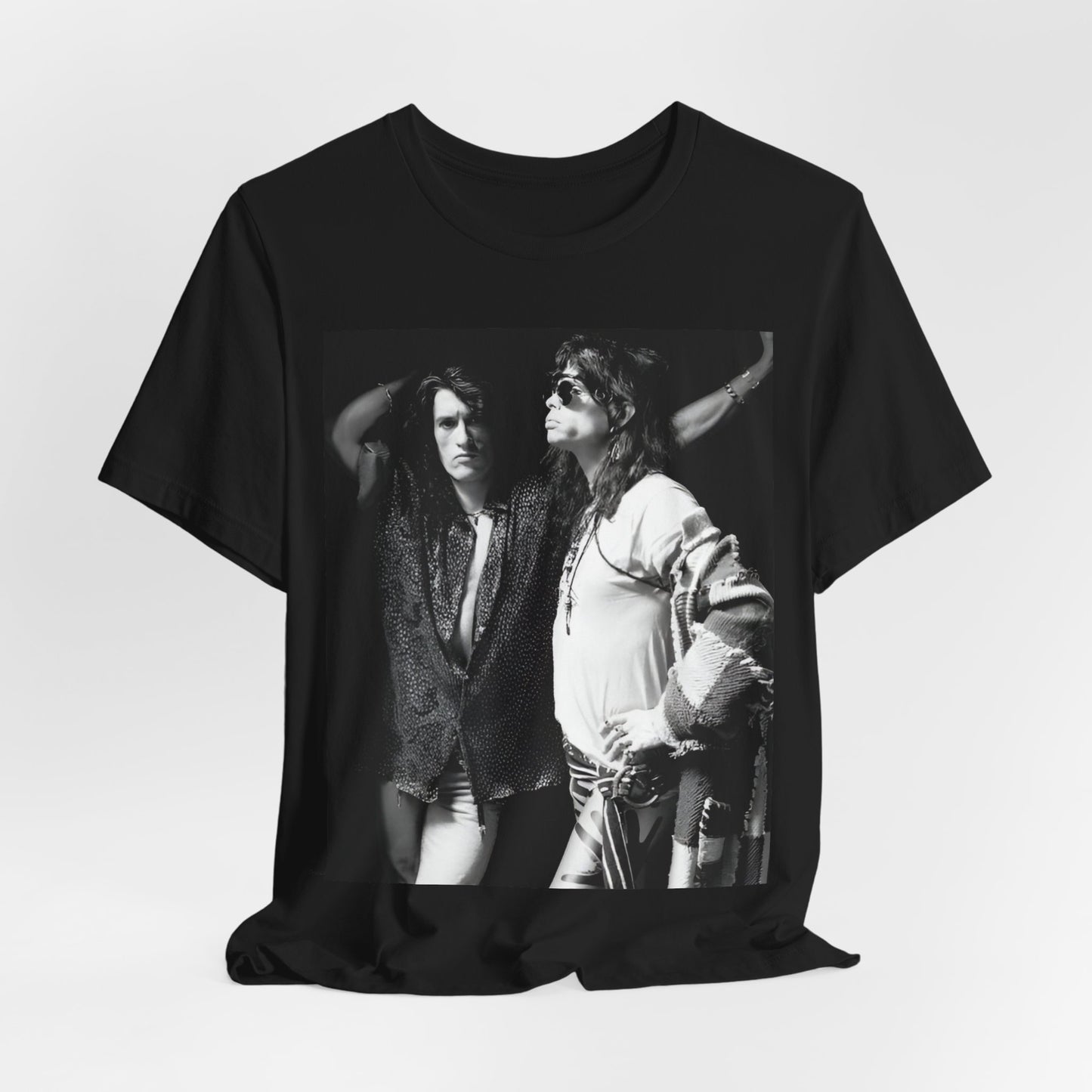 A black graphic t-shirt featuring a dynamic photo or illustration of Aerosmith's Steven Tyler and Joe Perry performing together on stage, highlighting their synergy.