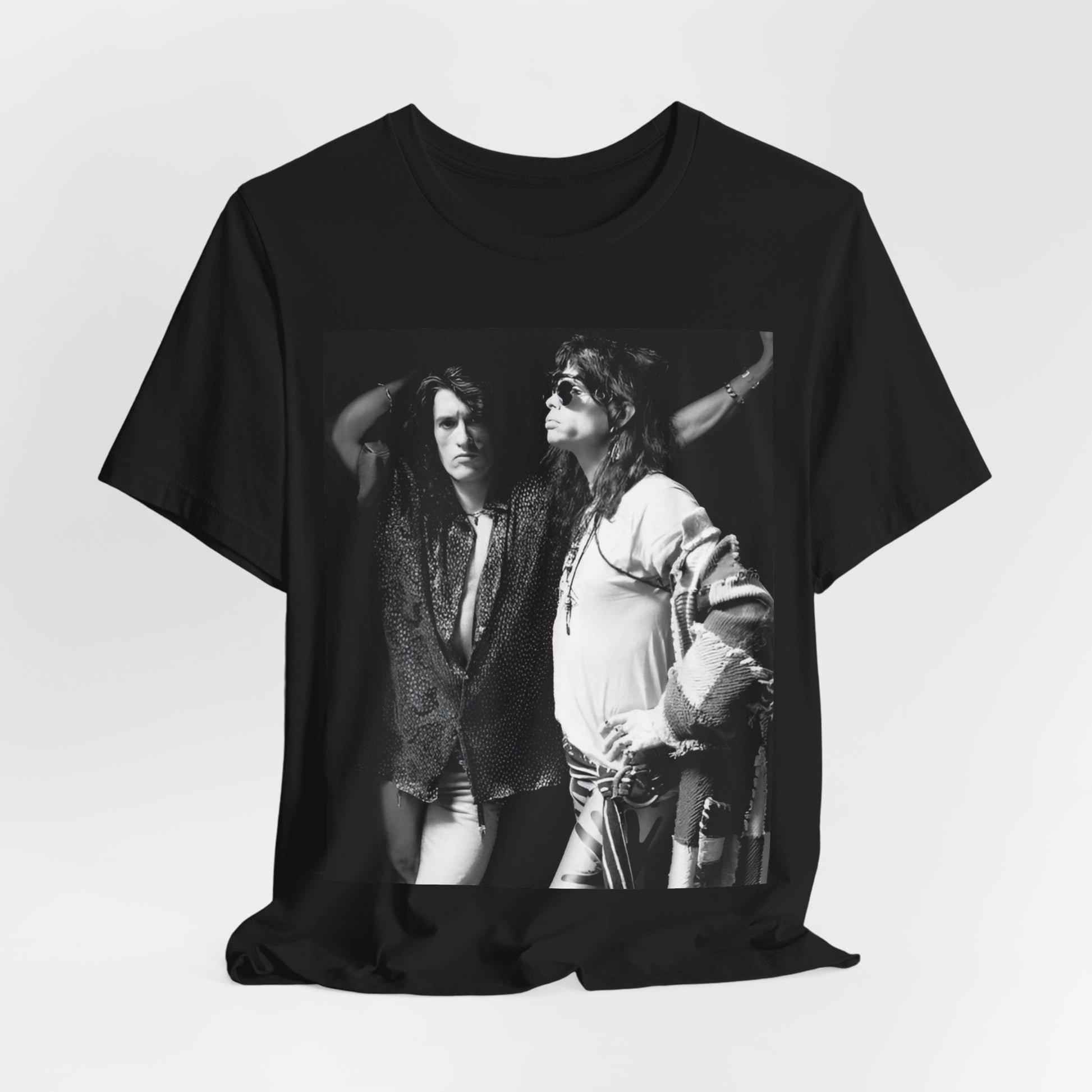 A black graphic t-shirt featuring a dynamic photo or illustration of Aerosmith's Steven Tyler and Joe Perry performing together on stage, highlighting their synergy.
