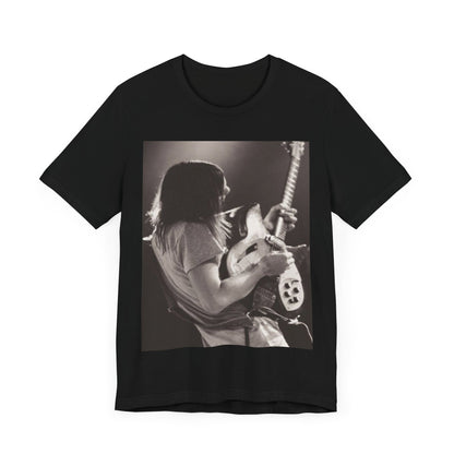 A black graphic t-shirt featuring a black and white graphic or photo of Tame Impala performing live on stage.
