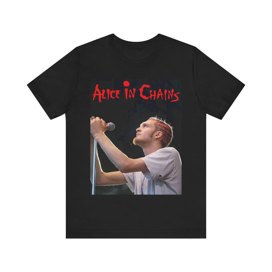 A black graphic t-shirt featuring the Alice In Chains logo in red, in a 90s grunge style.