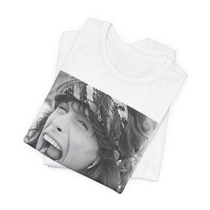 A black graphic t-shirt featuring a candid, dynamic photo of Aerosmith band members on tour in the 1970s, possibly showing action or interaction on stage or backstage.