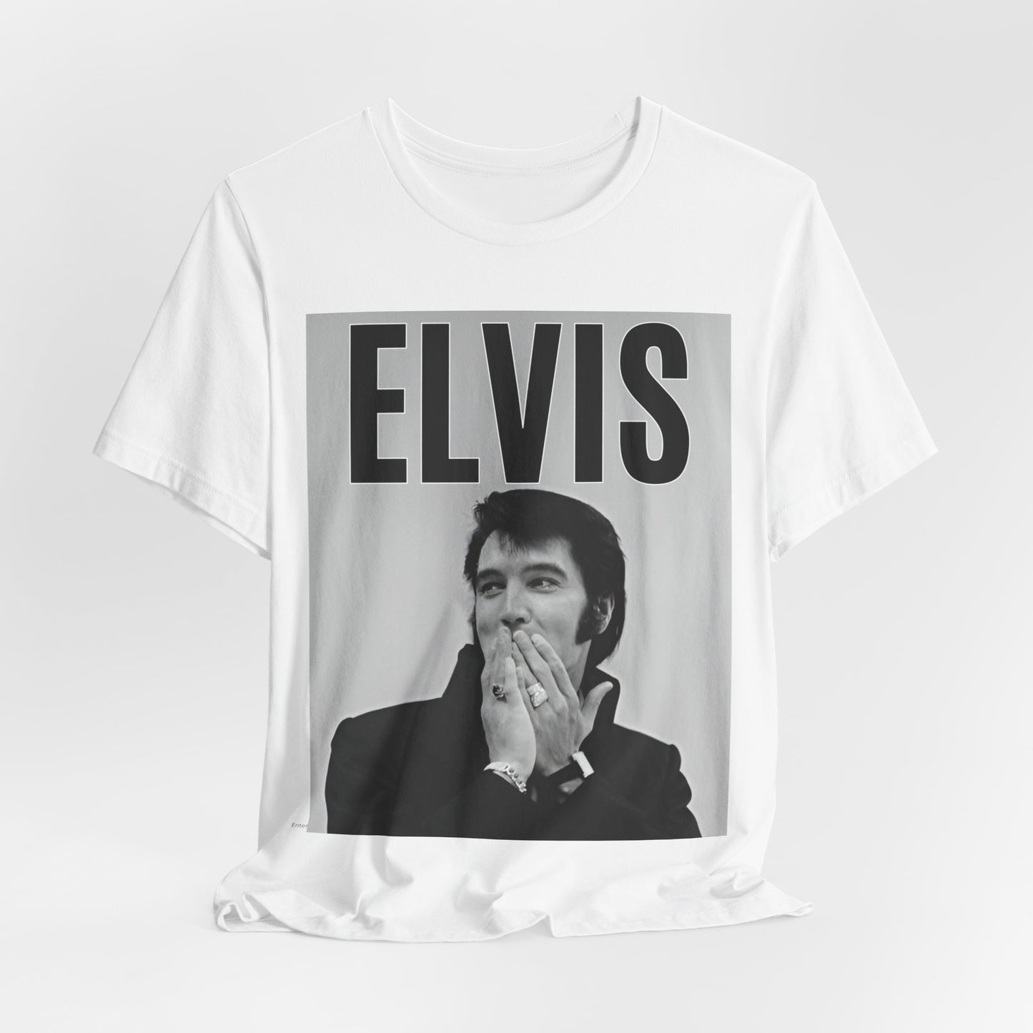A black graphic t-shirt featuring a retro graphic of Elvis Presley as a 'Rebel With A Cause.'