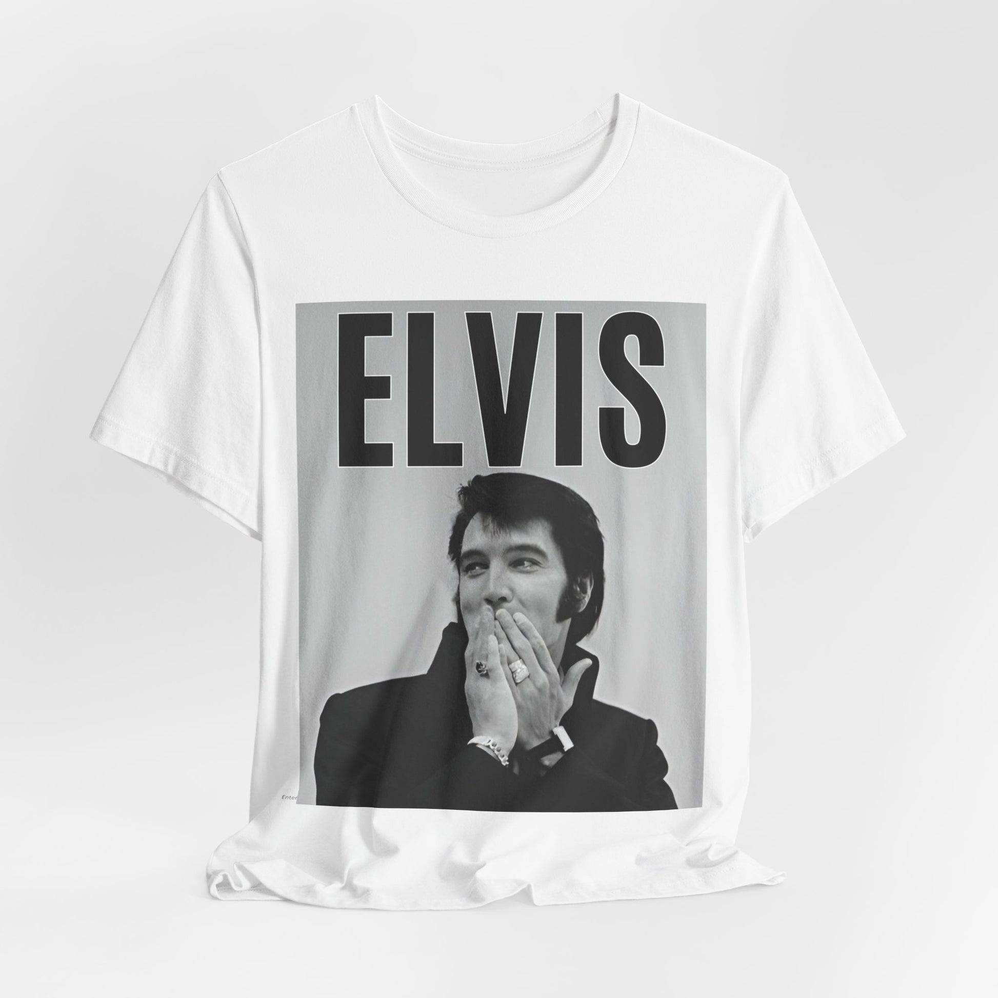 A black graphic t-shirt featuring a retro graphic of Elvis Presley as a 'Rebel With A Cause.'