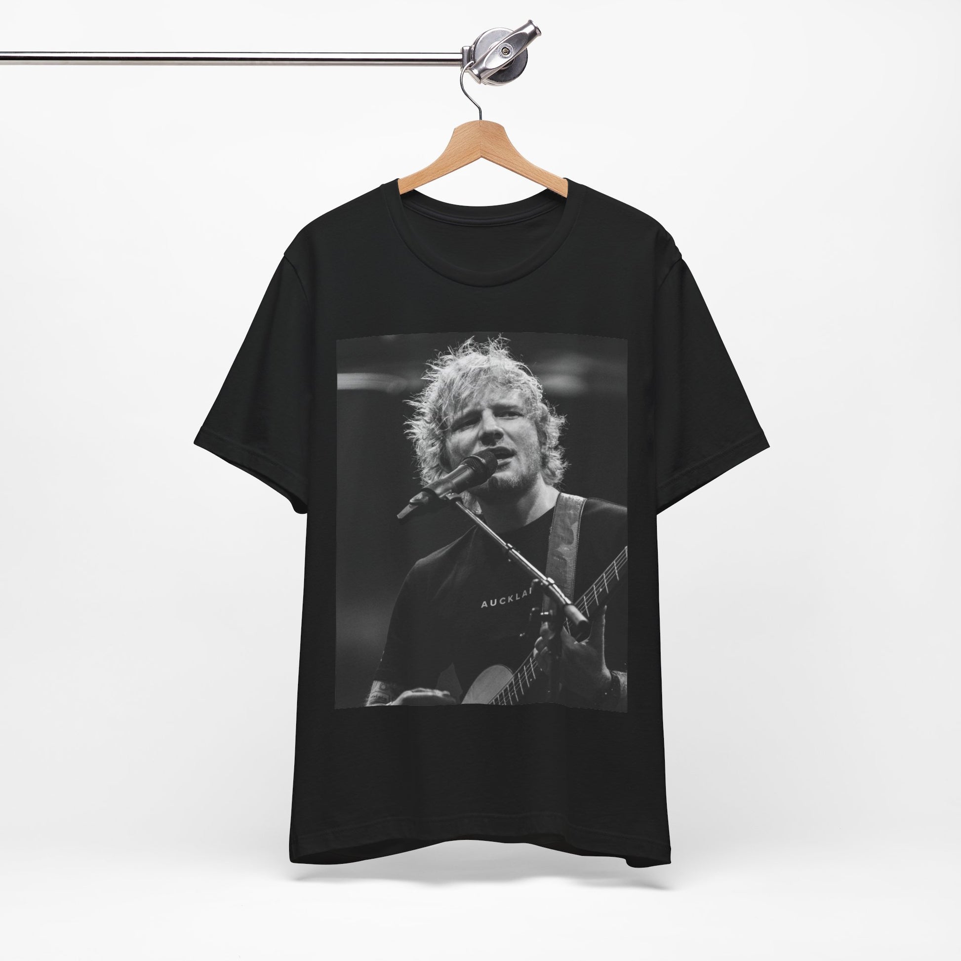 A black graphic t-shirt featuring a black and white photo of Ed Sheeran performing live.