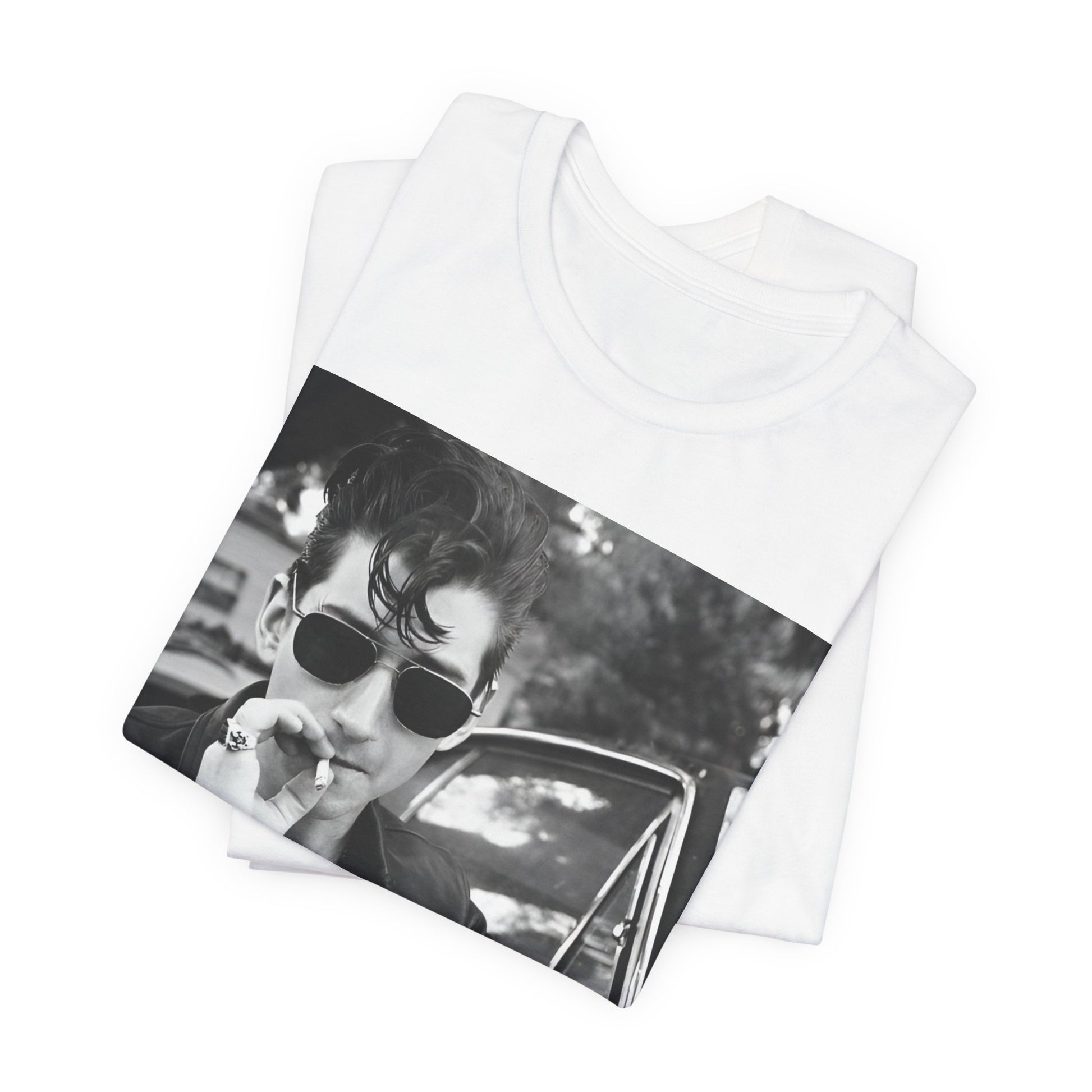 A black graphic t-shirt featuring a classic rock-style graphic of the Arctic Monkeys, possibly with band members in a stylized design.