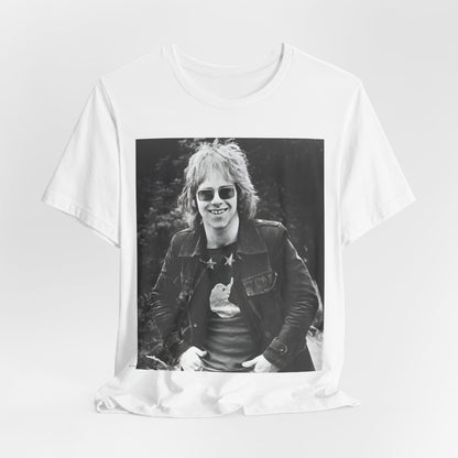 A black graphic t-shirt featuring a 70s black and white monochrome graphic or photo of Elton John.