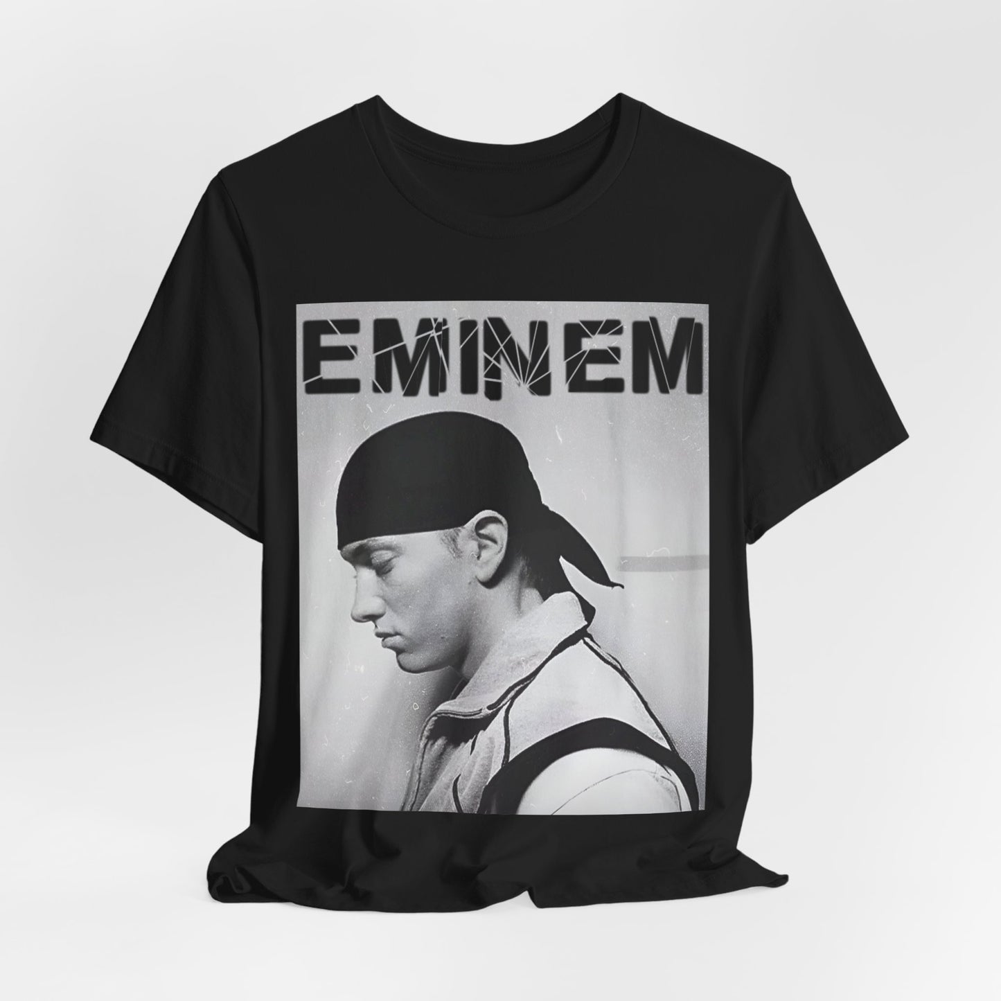 A black graphic t-shirt featuring a stylized graphic of Eminem as a modern rap legend.