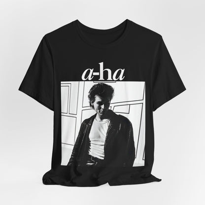 A black graphic t-shirt featuring a stylized pop art graphic inspired by A-HA's "Take On Me" music video from 1985.