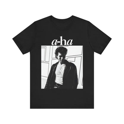 A black graphic t-shirt featuring a stylized pop art graphic inspired by A-HA's "Take On Me" music video from 1985.