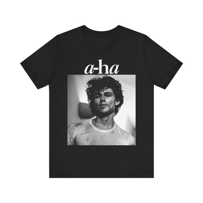 A black graphic t-shirt featuring the A-HA logo integrated with a black and white photo of the band members.