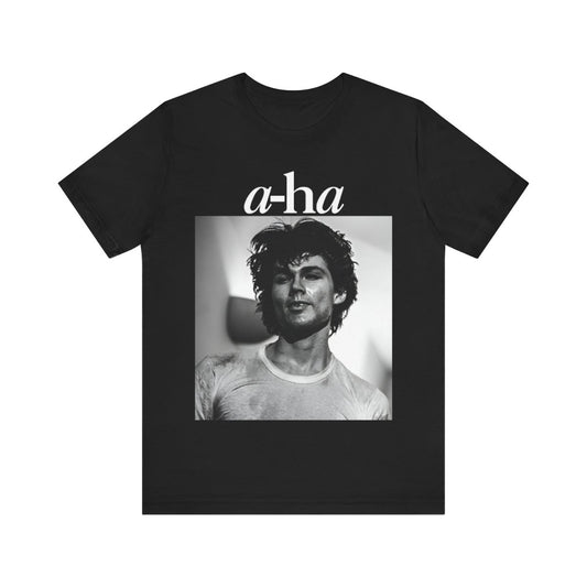 A black graphic t-shirt featuring the A-HA logo integrated with a black and white photo of the band members.