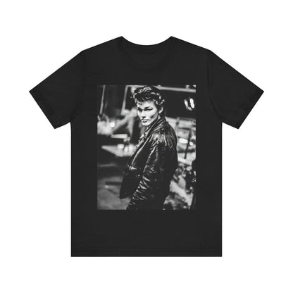 A black graphic t-shirt featuring a retro 80s tour graphic for the band A-HA, possibly showing concert elements or band members in a stylized design.