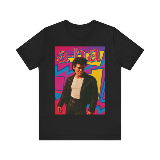 A black graphic t-shirt featuring a retro 80s pop art style illustration of the band A-HA, with vibrant colors and bold lines.