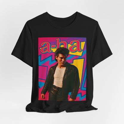 A black graphic t-shirt featuring a retro 80s pop art style illustration of the band A-HA, with vibrant colors and bold lines.
