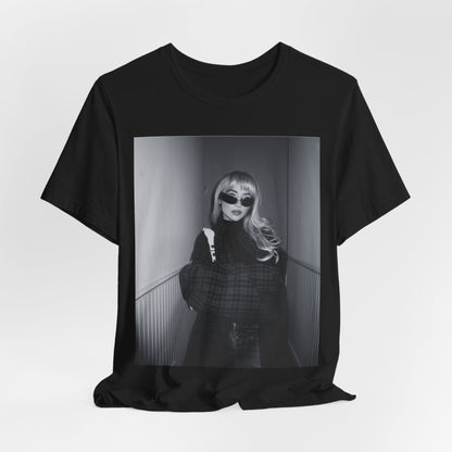 A black graphic t-shirt featuring a black and white glam pop diva graphic of Sabrina Carpenter.