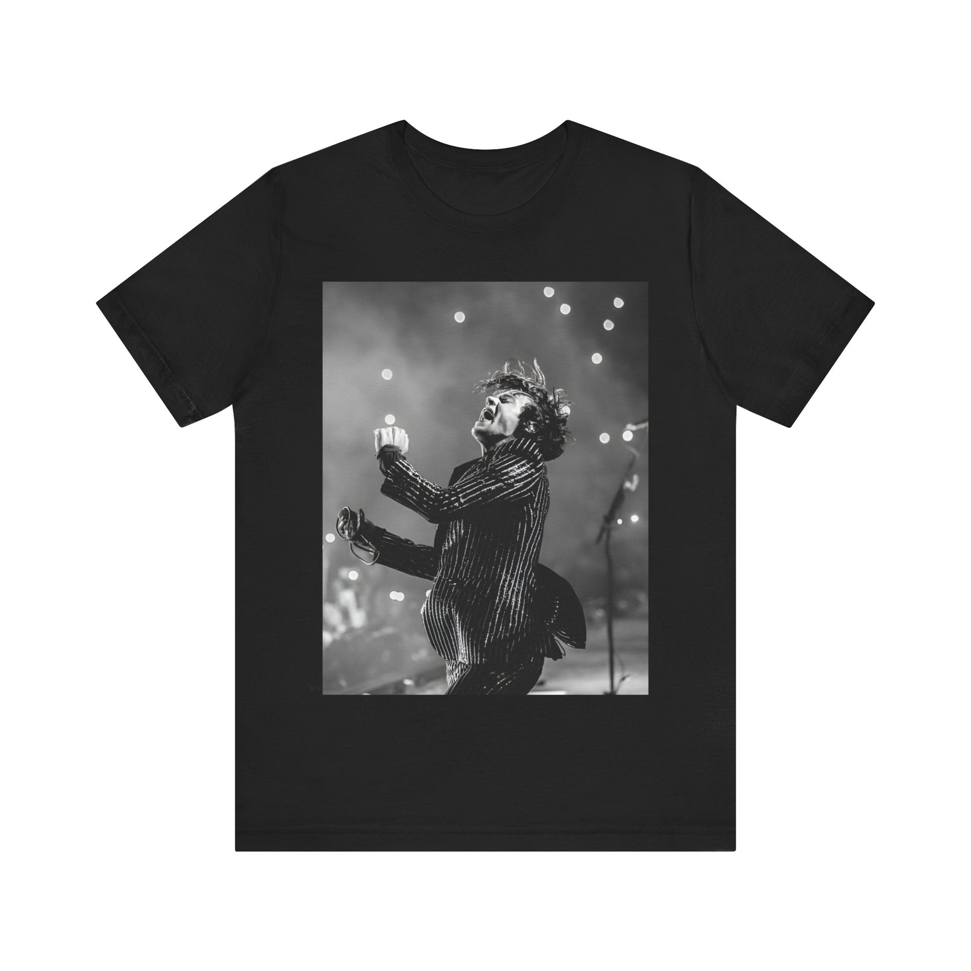 A black graphic t-shirt featuring a glamorous graphic or photo of Harry Styles performing on stage.
