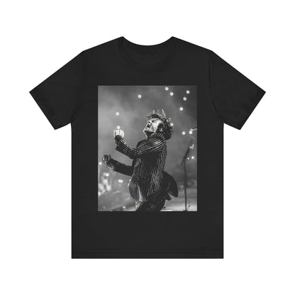 A black graphic t-shirt featuring a glamorous graphic or photo of Harry Styles performing on stage.