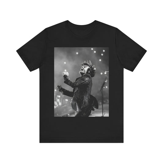 A black graphic t-shirt featuring a glamorous graphic or photo of Harry Styles performing on stage.