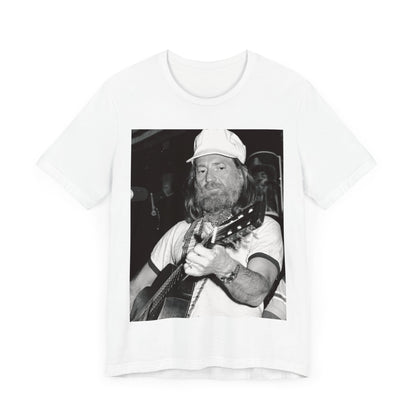 A black graphic t-shirt featuring a 70s cool free spirit graphic of Willie Nelson.