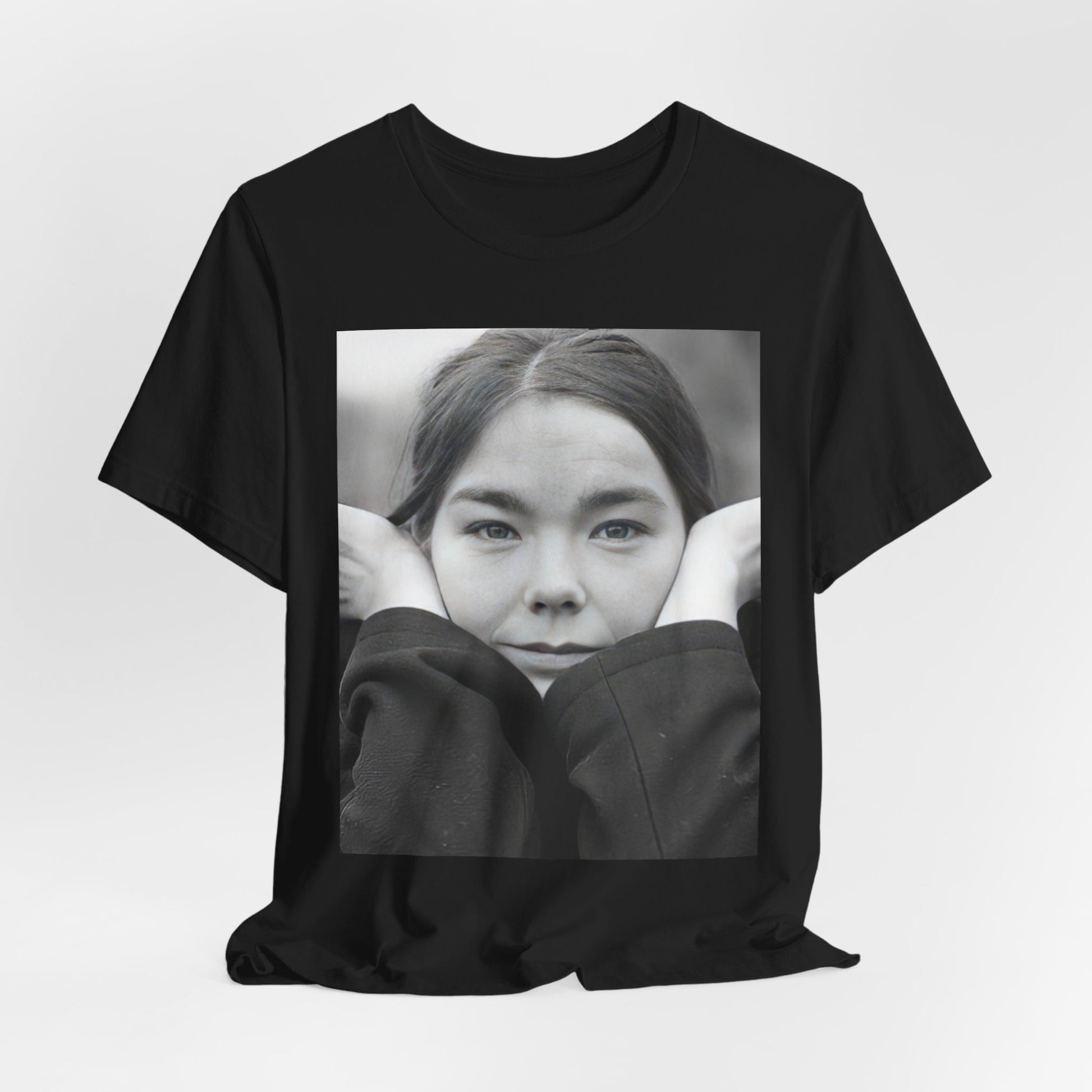 A black graphic t-shirt featuring a black and white portrait photo of Bjork.
