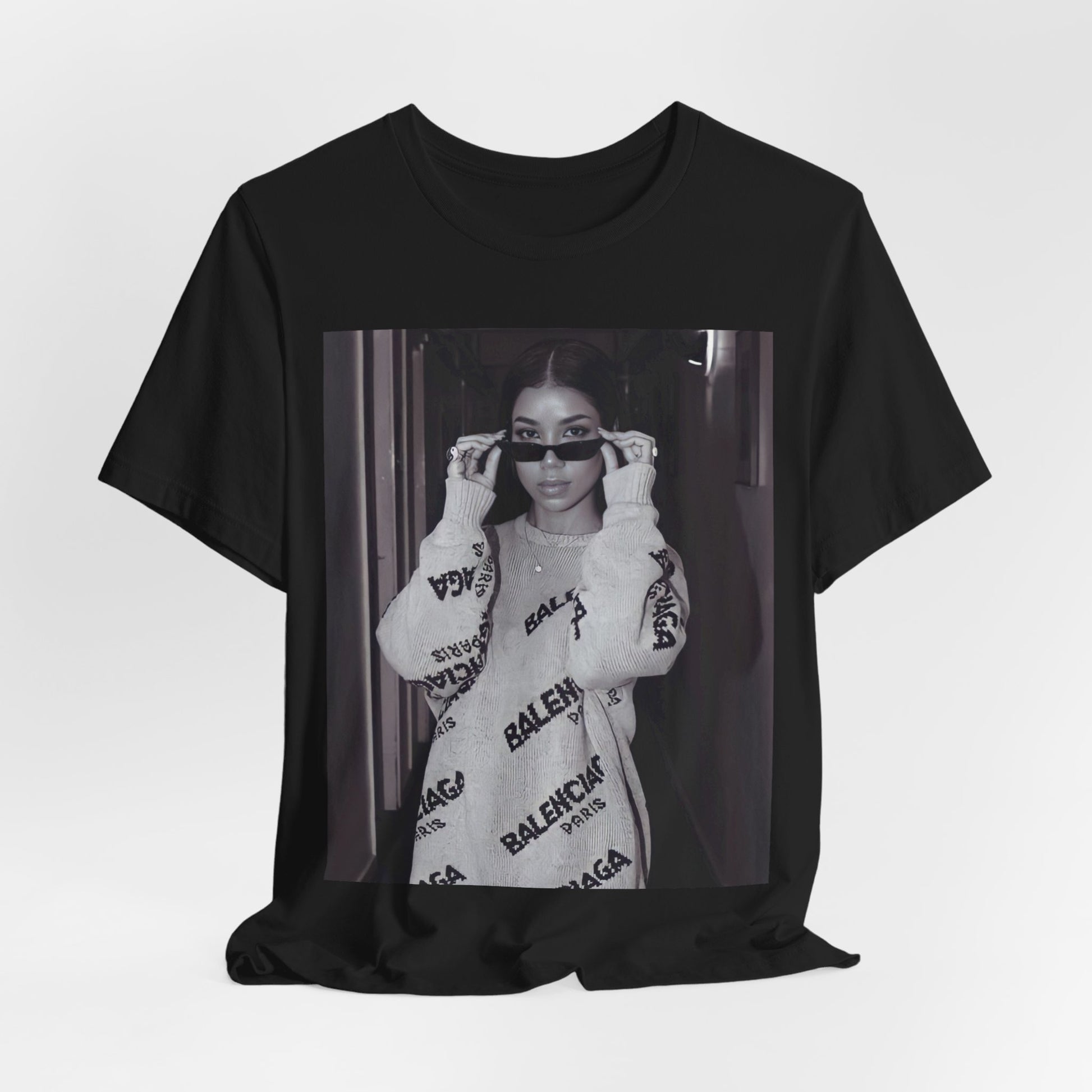 A black graphic t-shirt featuring a black and white, monochrome graphic or photo of Jhene Aiko.