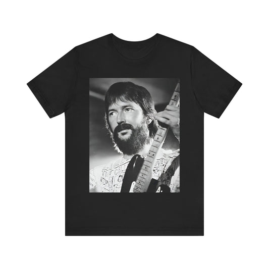 A black graphic t-shirt featuring a graphic of Eric Clapton as an authentic guitar god.