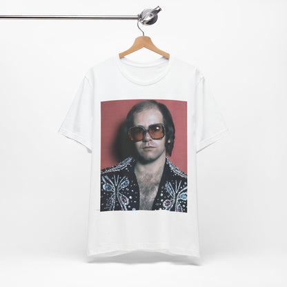 A black graphic t-shirt featuring a vintage glam rock icon graphic of Elton John.